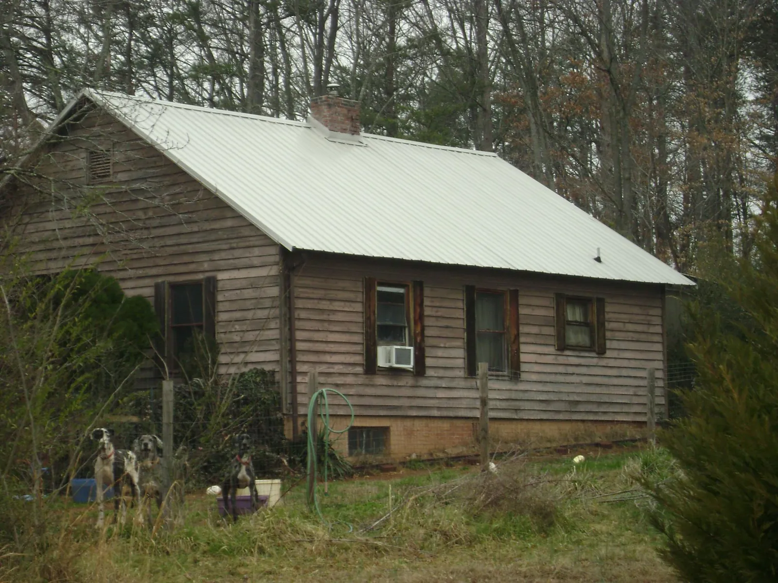White metal roof on an old wood sided farmhouse, from a Metal Roof Installation job in Grottoes